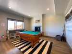 Lower level family game room: pool table and fireplace